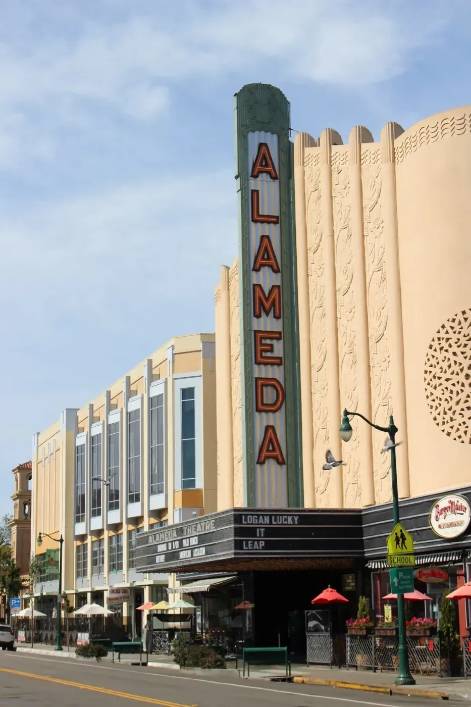 The Art Deco Alameda Theatre and neighboring storefronts along Park Street in downtown Alameda, California