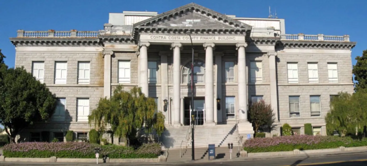 The historic Contra Costa County Courthouse in downtown Martinez, California, a multi-story classical stone civic building.