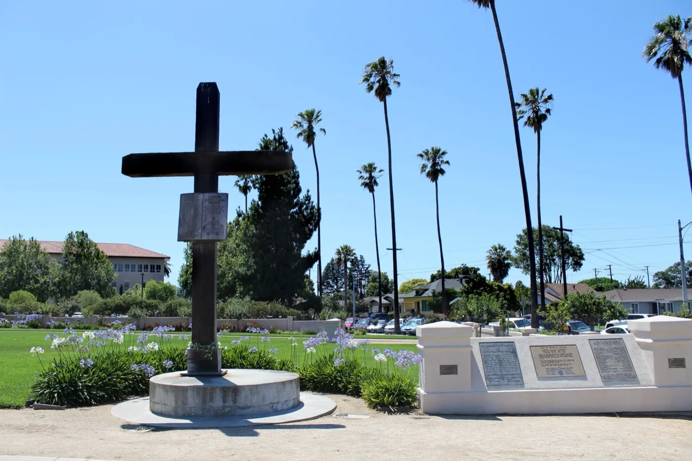 The facade of Mission Santa Clara de Asís, a historic Spanish mission church in Santa Clara, California, with its cross and bell
